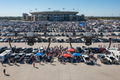 have the 2 drones scanning a large parking lot tailgate at a football game